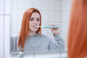 lady brushing her teeth